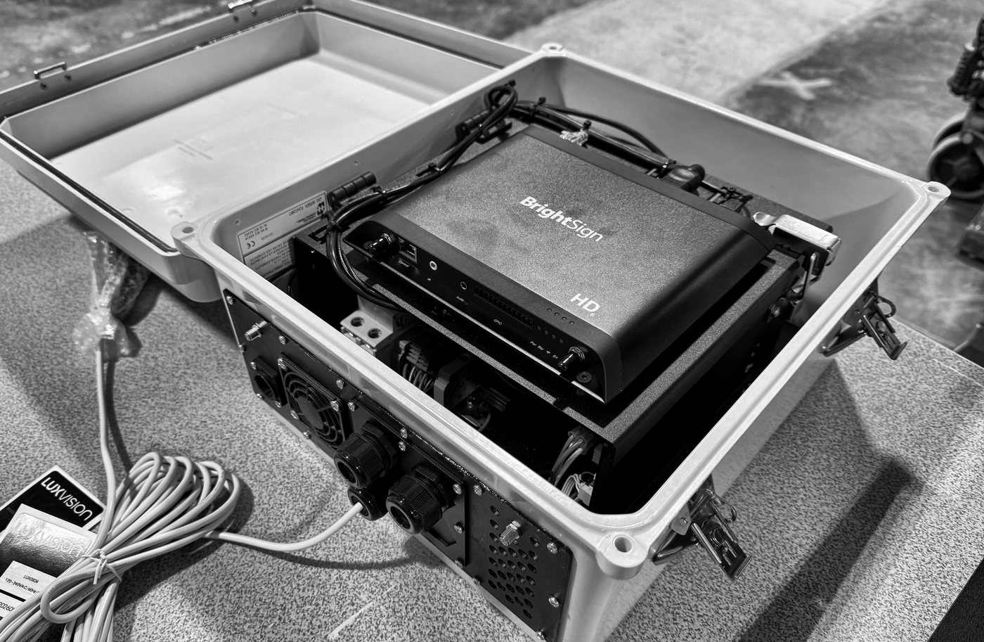 A PROLUX NEMA enclosure open on the bench in Edmonton, the playback tray wired and fitted